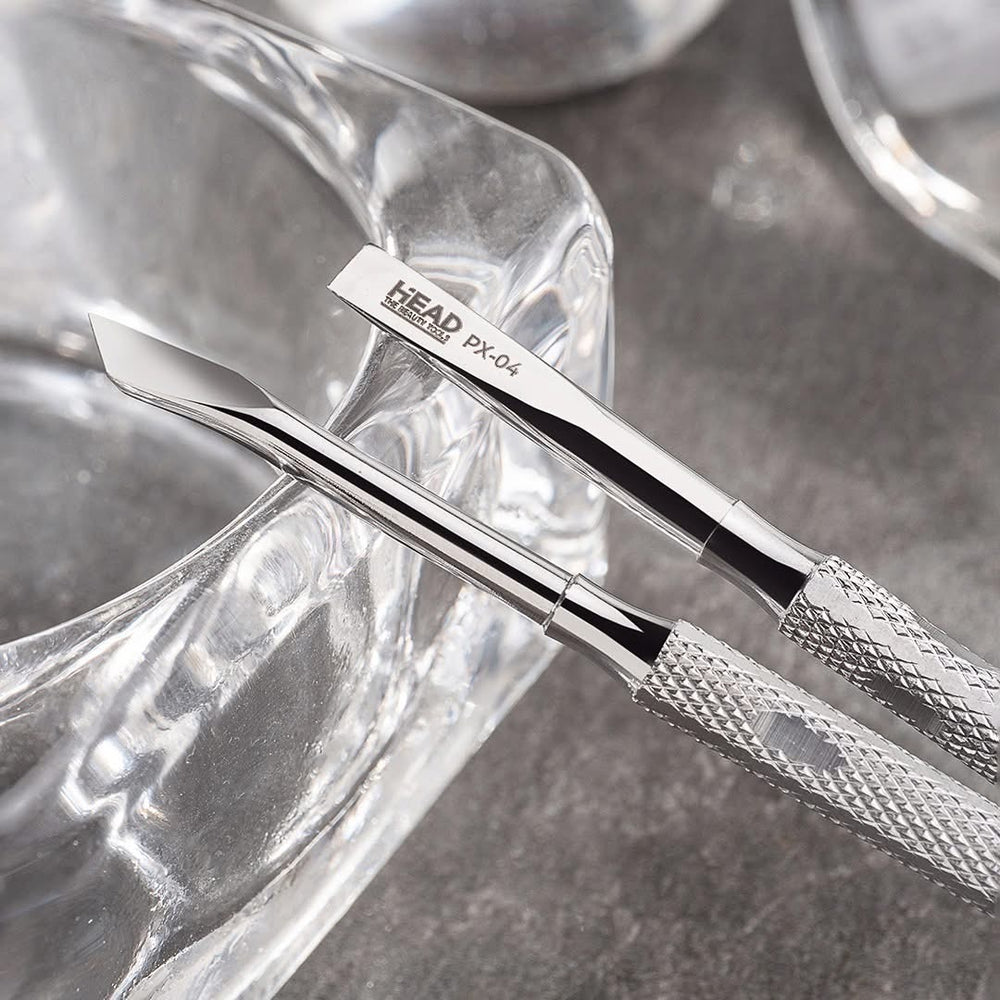 Metal tool with 'HEAD' branding on a textured surface