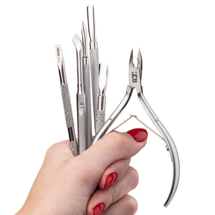 Set of beauty tools with HEAD TOOLS branding - cuticle nippers, scissors and pushers for professional manicure and pedicure.