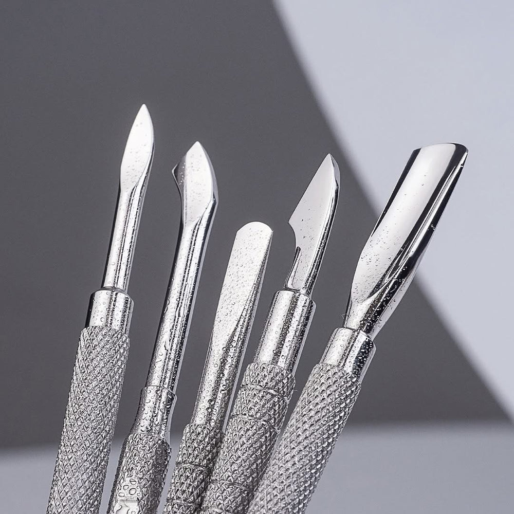 Silver professional stainless steel cuticle pusher with a textured handle and a polished working end instruments on a gray background