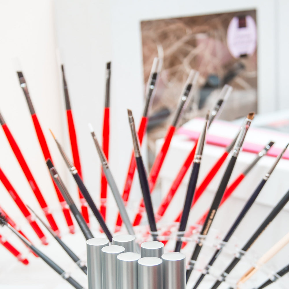 Thin precision eyebrow brush with soft bristles and ergonomic handle – ideal for fine brow detailing and tint application